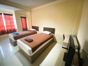 Ένα ή περισσότερα κρεβάτια σε δωμάτιο στο Hotel Grand Citra Prabumulih