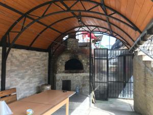 an outdoor brick oven with a table in front of it at Vila Alpina Olănești in Băile Olăneşti