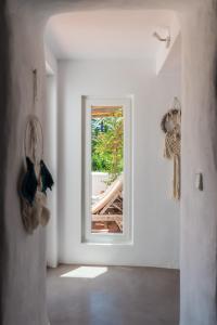 
a room with a window and a cat on the floor at Agroturismo Ca Sa Vilda Marge in Sant Joan de Labritja
