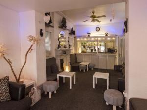 - un salon avec un canapé, des tables et un bar dans l'établissement The Marsden Hotel, à Blackpool