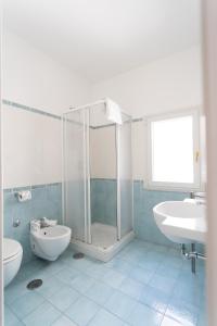 a bathroom with a shower and a toilet and a sink at LUIMAR Holiday House in Amalfi