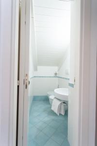 a white bathroom with a sink and a toilet at LUIMAR Holiday House in Amalfi