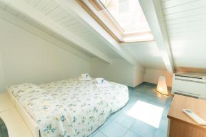 a attic bedroom with a bed and a skylight at LUIMAR Holiday House in Amalfi