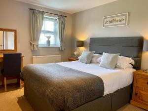 a bedroom with a large bed and a window at New Farm Cheshire B&B in Winsford