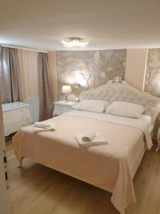 a bedroom with a large bed with towels on it at Holiday Home Mila in Dubrovnik