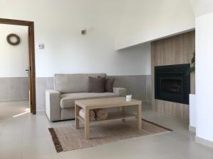 a living room with a couch and a coffee table at Horta da Rosa - Adults Only in Alvito