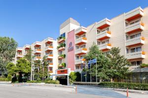 a large apartment building with a street in front of it at Oasis Hotel Apartments in Athens