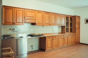 a kitchen with wooden cabinets and stainless steel appliances at Az. Agr. Tenuta La Casetta in Mama +23 photos