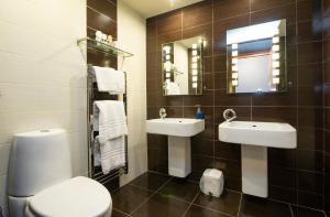 a bathroom with two sinks and a toilet and a mirror at The Auld Kirk in Ballater +72 photos