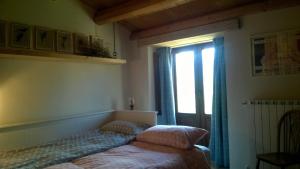 a bedroom with a bed and a large window at Majellame in Caramanico Terme