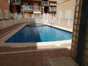 a swimming pool in the middle of a building at Casas Holiday - Puerto Romano in La Mata