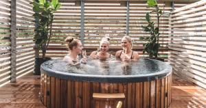 three girls in a jacuzzi in a hot tub at Hotel Brandan in Tórshavn
