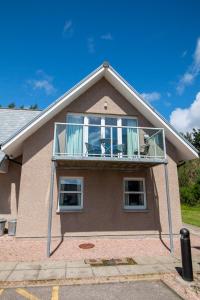 a house with a balcony on top of it at Inchmarlo Golf Resort, Banchory Villa 38 AS00482F in Inchmarlo