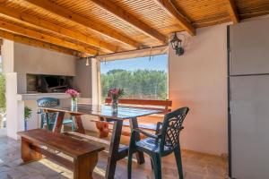 a dining room with a table and chairs and a refrigerator at Villa Sofia in Mesimvría