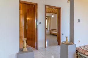 a room with two vases on a table and a hallway at Villa Sofia in Mesimvría