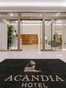 a lobby with a hotel sign on a rug at Acandia Hotel in Rhodes Town