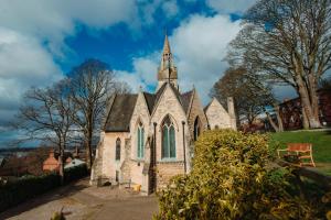 an old church with a steeple on a hill at The Old Palace Lodge in Lincoln