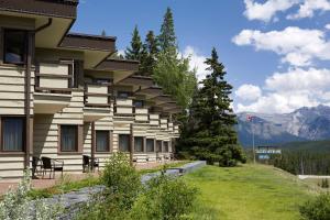 a house on a hill overlooking a mountain range at The Juniper Hotel & Bistro in Banff