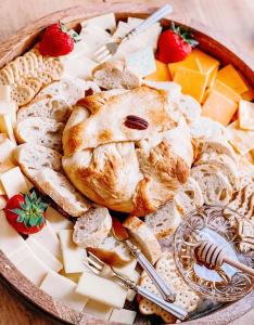 a plate of food with bread and cheese and strawberries at Woodbridge Inn Bed & Breakfast in Woodstock