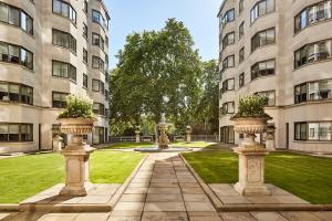 two stone pillars in a courtyard with two buildings at Arlington House Apartments in London