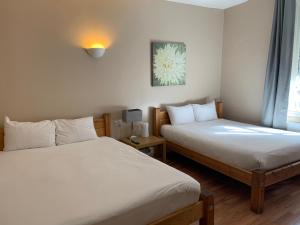 a bedroom with two beds and a window at New Union ADULTS ONLY in Manchester +25 photos