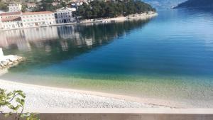 a view of a body of water with buildings at Apartman Ružica in Pučišća