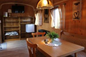 a dining room with a wooden table with a plant on it at Rolling Home in Eppingen