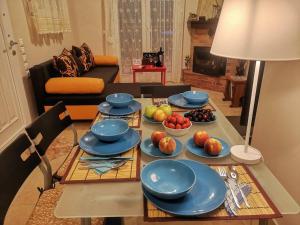 a table with plates and bowls of fruit on it at Nikiti Spathies Resort - Maizonette at Nikiti Village in Nikiti