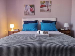 a bedroom with a large bed with blue pillows at Nikiti Spathies Resort - Maizonette at Nikiti Village in Nikiti +40 photos