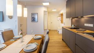 a kitchen with a table with plates on it at Alpine Appartement Top 3 by AA Holiday Homes in Tauplitz