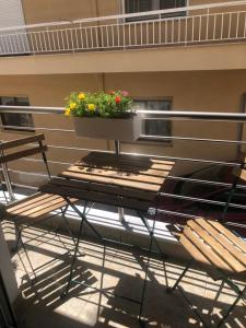 a table and chairs with a planter on top of it at The green apartment in Kavála