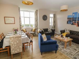 a living room with a table and chairs and a couch at Westonby Lodge in Whitby