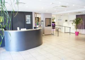 a lobby with a reception counter in a building at Campanile Dijon Centre - Gare in Dijon