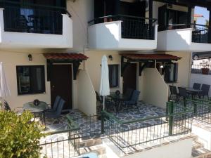 a balcony of a hotel with chairs and tables at Dasea Houses in Ormos Panagias