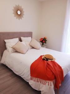 a bedroom with a bed with a red dress on it at NICORÉS in Irún