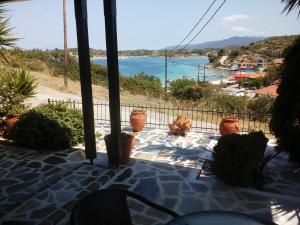 a view of the ocean from a balcony with potted plants at Dasea Houses in Ormos Panagias