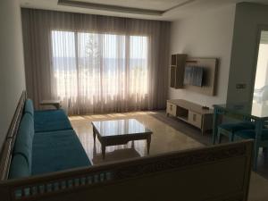 a living room with a couch and a table at Arabesque Style - 2 appartements in Kelibia