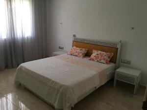 a bedroom with a large bed with two pillows at Arabesque Style - 2 appartements in Kelibia