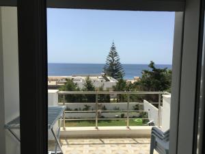 a view of the ocean from a balcony at Arabesque Style - 2 appartements in Kelibia