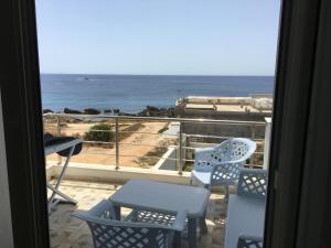a room with a view of the ocean from a balcony at Arabesque Style - 2 appartements in Kelibia