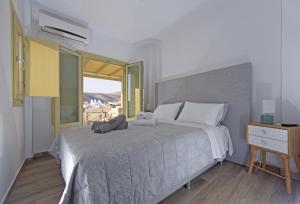 a bedroom with a bed with two towels on it at Diasino Apartments and Car Rental in Katapola