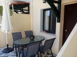a table and chairs in a room with a window at Dasea Houses in Ormos Panagias