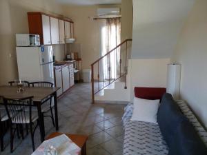 a living room with a couch and a table at Dasea Houses in Ormos Panagias