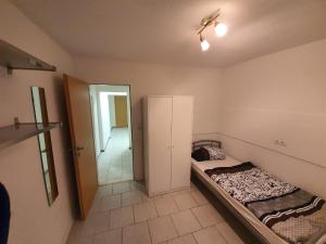 1 dormitorio con 1 cama y puerta que da a un pasillo en MK Hostel Bremen, en Bremen