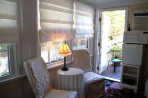 a living room with two chairs and a table with a lamp at Artful Lodger in Newport