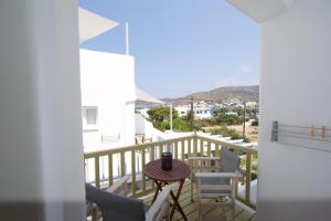 a balcony with a table and chairs and a view at Diasino Apartments and Car Rental in Katapola