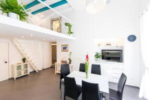 a white living room with a table and chairs at Tony's Place in Dubrovnik