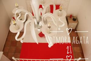 a chandelier with a red skirt in a room at Dimora Agata 21 in Ostuni