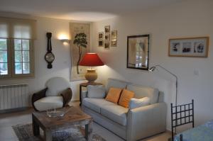 a living room with a couch and a table at La Bégude Du Pascouren in Fayence