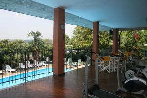 a home gym with a view of a pool at Residence Miralago Rooms & Apartments in Manerba del Garda